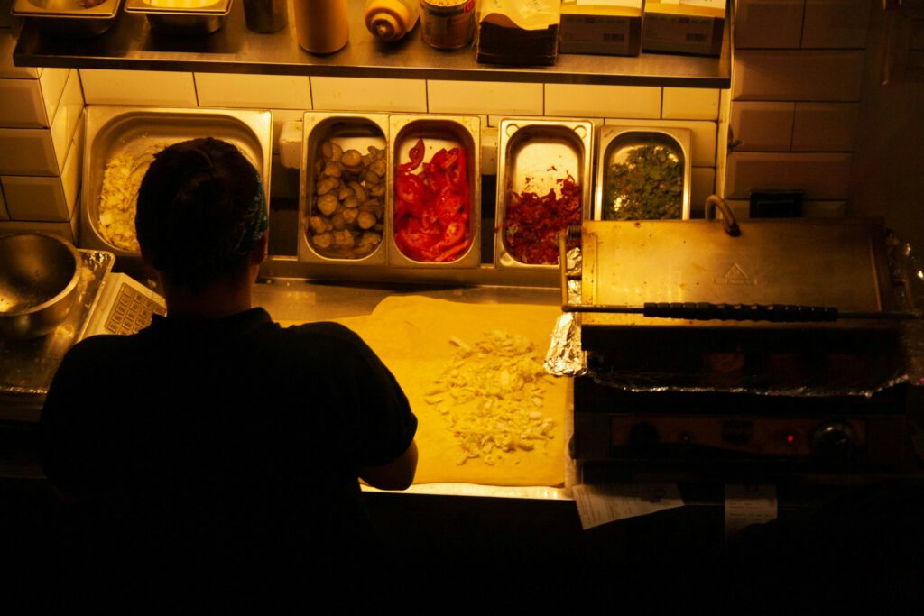 a person sitting at a counter in a kitchen